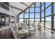 Living area with wall of windows, stone fireplace, and stylish decor at 3386 Governors Island Dr, Denver, NC 28037