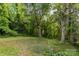 Lush backyard with mature trees at 370 Old Camden Rd, Lancaster, SC 29720