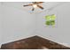 A cozy bedroom featuring hardwood floors, a ceiling fan, and natural light from a window at 370 Old Camden Rd, Lancaster, SC 29720
