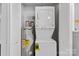 Convenient laundry area featuring a stacked washer and dryer with a water heater at 370 Old Camden Rd, Lancaster, SC 29720