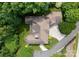 Aerial view of an elegant home with a circular driveway surrounded by lush green trees at 3815 Stoney Ridge Trl, Charlotte, NC 28210