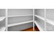 Bright walk-in closet with custom built-in shelving and ample storage space and wood floors at 3815 Stoney Ridge Trl, Charlotte, NC 28210