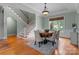 Dining room showcasing a staircase, elegant lighting, and a large window at 3815 Stoney Ridge Trl, Charlotte, NC 28210