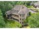 Spacious home featuring a deck, screened porch, brick facade, and beautifully landscaped yard at 3815 Stoney Ridge Trl, Charlotte, NC 28210