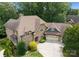 Charming brick home with a three-car garage and well-manicured front lawn and mature trees at 3815 Stoney Ridge Trl, Charlotte, NC 28210