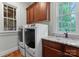 Laundry room featuring granite counters, upper cabinets and modern washer and dryer units at 3815 Stoney Ridge Trl, Charlotte, NC 28210