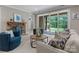 Comfortable living room features a stone fireplace and sliding glass doors to the backyard at 3815 Stoney Ridge Trl, Charlotte, NC 28210
