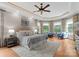 Generously sized main bedroom featuring a large bay window, tray ceiling, and hardwood flooring at 3815 Stoney Ridge Trl, Charlotte, NC 28210