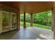 Covered patio with brick columns, stained ceiling, and a view of the lush, green backyard at 3815 Stoney Ridge Trl, Charlotte, NC 28210