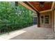 Expansive covered patio with stone flooring, wood ceiling, and scenic views of the lush backyard at 3815 Stoney Ridge Trl, Charlotte, NC 28210