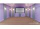 Movie room with purple walls, gray accents, and carpeted flooring at 3815 Stoney Ridge Trl, Charlotte, NC 28210