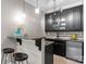 Well-equipped wet bar with granite countertops, wine fridge, and glass cabinets at 3815 Stoney Ridge Trl, Charlotte, NC 28210