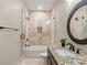 Bathroom featuring walk-in shower, granite countertops, and a decorative mirror at 405 Gladelynn Way, Waxhaw, NC 28173