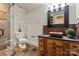 Elegant bathroom featuring a glass-enclosed shower and rustic vanity with a vessel sink, creating a spa-like retreat at 405 Gladelynn Way, Waxhaw, NC 28173