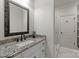 Bathroom with granite countertops, decorative mirror and walk-in shower at 405 Gladelynn Way, Waxhaw, NC 28173