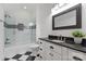 Modern bathroom with a glass-enclosed shower and a black and white vanity at 405 Gladelynn Way, Waxhaw, NC 28173