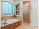 Bright bathroom featuring a large tub under a window and a standing shower at 405 Gladelynn Way, Waxhaw, NC 28173