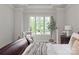 Bright bedroom featuring a view of the green landscape outside a large window at 405 Gladelynn Way, Waxhaw, NC 28173
