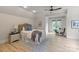 Inviting bedroom with a ceiling fan, wooden floors and access to a balcony at 405 Gladelynn Way, Waxhaw, NC 28173