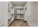 Spacious walk-in closet with custom shelving and drawers for organized storage at 405 Gladelynn Way, Waxhaw, NC 28173