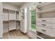 Bright, well-organized walk-in closet featuring a window and custom storage solutions at 405 Gladelynn Way, Waxhaw, NC 28173