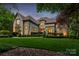 Elegant home with a lush, green lawn and meticulously manicured landscaping at 405 Gladelynn Way, Waxhaw, NC 28173