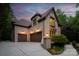Exterior of home featuring a three-car garage and manicured landscaping at 405 Gladelynn Way, Waxhaw, NC 28173