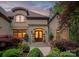 Inviting front entrance with a stone archway and beautifully landscaped garden at 405 Gladelynn Way, Waxhaw, NC 28173