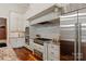A gourmet kitchen with white cabinets, stainless steel appliances, and granite countertops provides an elegant cooking space at 405 Gladelynn Way, Waxhaw, NC 28173