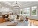 Open-concept living room with hardwood floors, a large sofa, and lots of natural light at 405 Gladelynn Way, Waxhaw, NC 28173