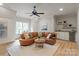 Living room with hardwood floors, large sectional couch, and wet bar at 405 Gladelynn Way, Waxhaw, NC 28173