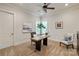 A cozy home office with a wooden desk, and comfortable seating with an abundance of natural light creates an inviting workspace at 405 Gladelynn Way, Waxhaw, NC 28173