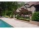 Inviting pool area with lush landscaping and hardscape, showcasing a private outdoor retreat at 405 Gladelynn Way, Waxhaw, NC 28173