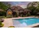 Backyard pool featuring landscaped borders and a well-maintained lawn at 405 Gladelynn Way, Waxhaw, NC 28173
