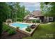 Inviting pool area with lounge chairs and lush landscaping offers a serene outdoor escape at 405 Gladelynn Way, Waxhaw, NC 28173