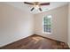 This bedroom features hardwood floors, a ceiling fan, and natural light from a large window at 4100 B Christine Ln, Waxhaw, NC 28173