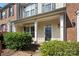 Inviting covered front porch with brick accents and lush green shrubs at 4100 B Christine Ln, Waxhaw, NC 28173