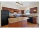 Spacious kitchen with dark wood cabinets, a central island, and modern appliances at 4100 B Christine Ln, Waxhaw, NC 28173