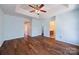 Large main bedroom featuring a tray ceiling, hardwood floors, and ample natural light, creating a comfortable and serene retreat at 4100 B Christine Ln, Waxhaw, NC 28173
