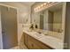 A well-lit bathroom featuring tiled walls and a sink with a large mirror at 413 N Mulberry St, Cherryville, NC 28021