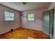 Bedroom with hardwood floors, two windows providing ample natural light, and a soothing ambiance at 413 N Mulberry St, Cherryville, NC 28021