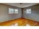 Bright bedroom featuring hardwood floors, natural light from two windows, and neutral decor at 413 N Mulberry St, Cherryville, NC 28021