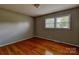 Cozy bedroom with hardwood floors, a bright window, and a serene atmosphere for relaxation at 413 N Mulberry St, Cherryville, NC 28021