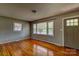 Inviting living room featuring gleaming hardwood floors, ample natural light, and neutral paint tones at 413 N Mulberry St, Cherryville, NC 28021