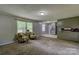 Open concept living area with plush carpeting and a seamless flow into the adjacent kitchen space at 413 N Mulberry St, Cherryville, NC 28021