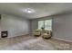 Comfortable living room with neutral carpeting, bright windows, and ample space for seating at 413 N Mulberry St, Cherryville, NC 28021