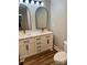 This bathroom has dual sinks with modern fixtures and wood-look flooring at 423 S Rhyne St, Dallas, NC 28034