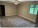 This bedroom features neutral paint, carpet, a ceiling fan and a bright window at 423 S Rhyne St, Dallas, NC 28034