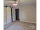 Bedroom featuring carpet, a ceiling fan, and a sliding barn door at 423 S Rhyne St, Dallas, NC 28034