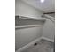 A small walk-in closet with a single shelf and carpeted flooring at 423 S Rhyne St, Dallas, NC 28034